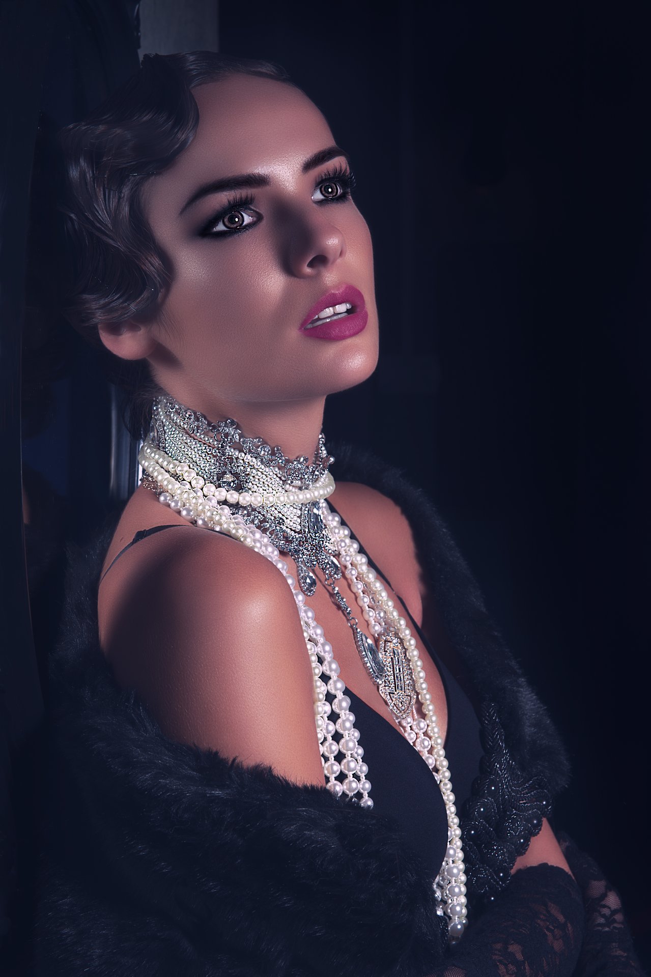 Period glamour portrait, pearls, fur, low-key colour